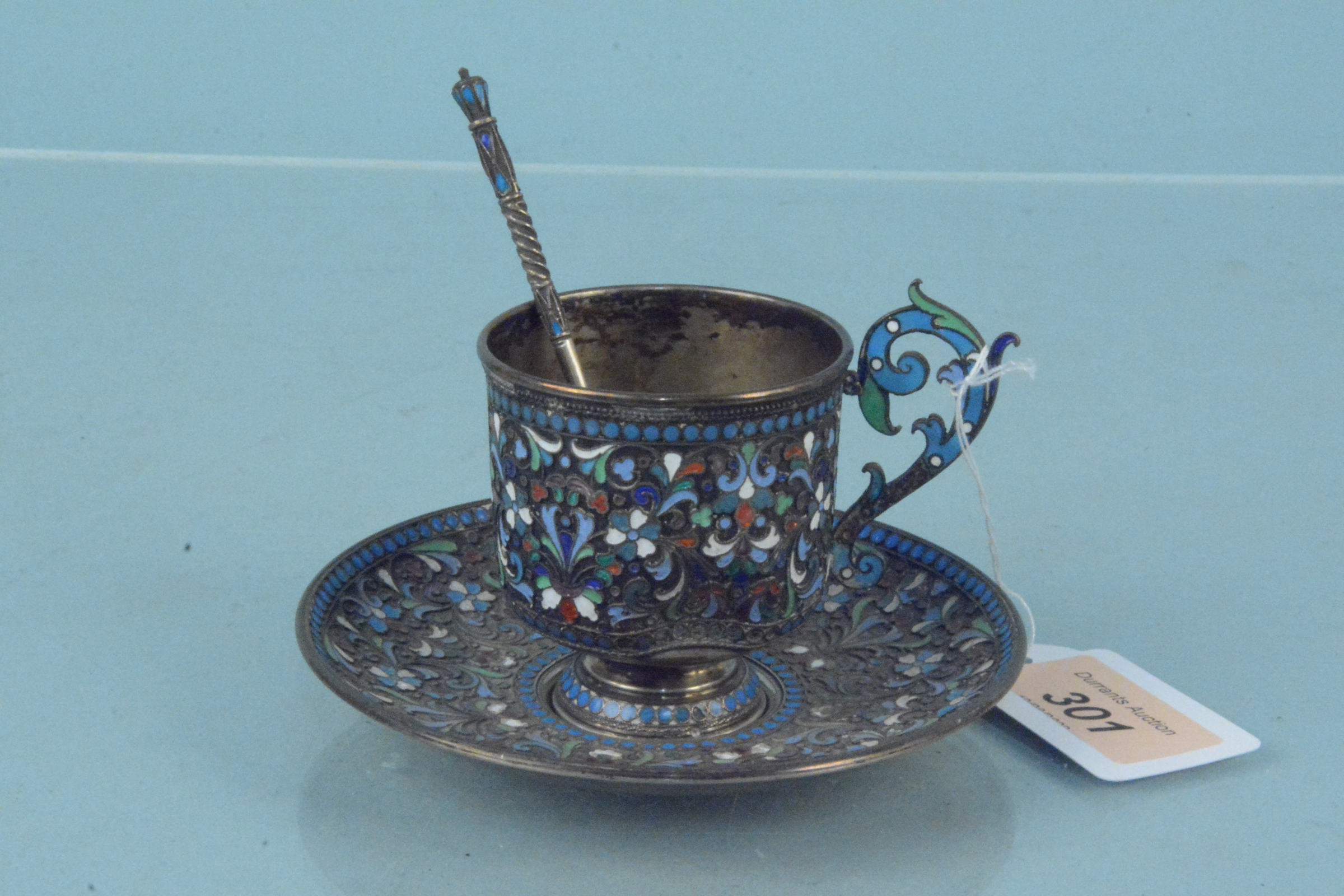 A Russian silver cloisonne cup, saucer and spoon, all with Kokoshnik mark,