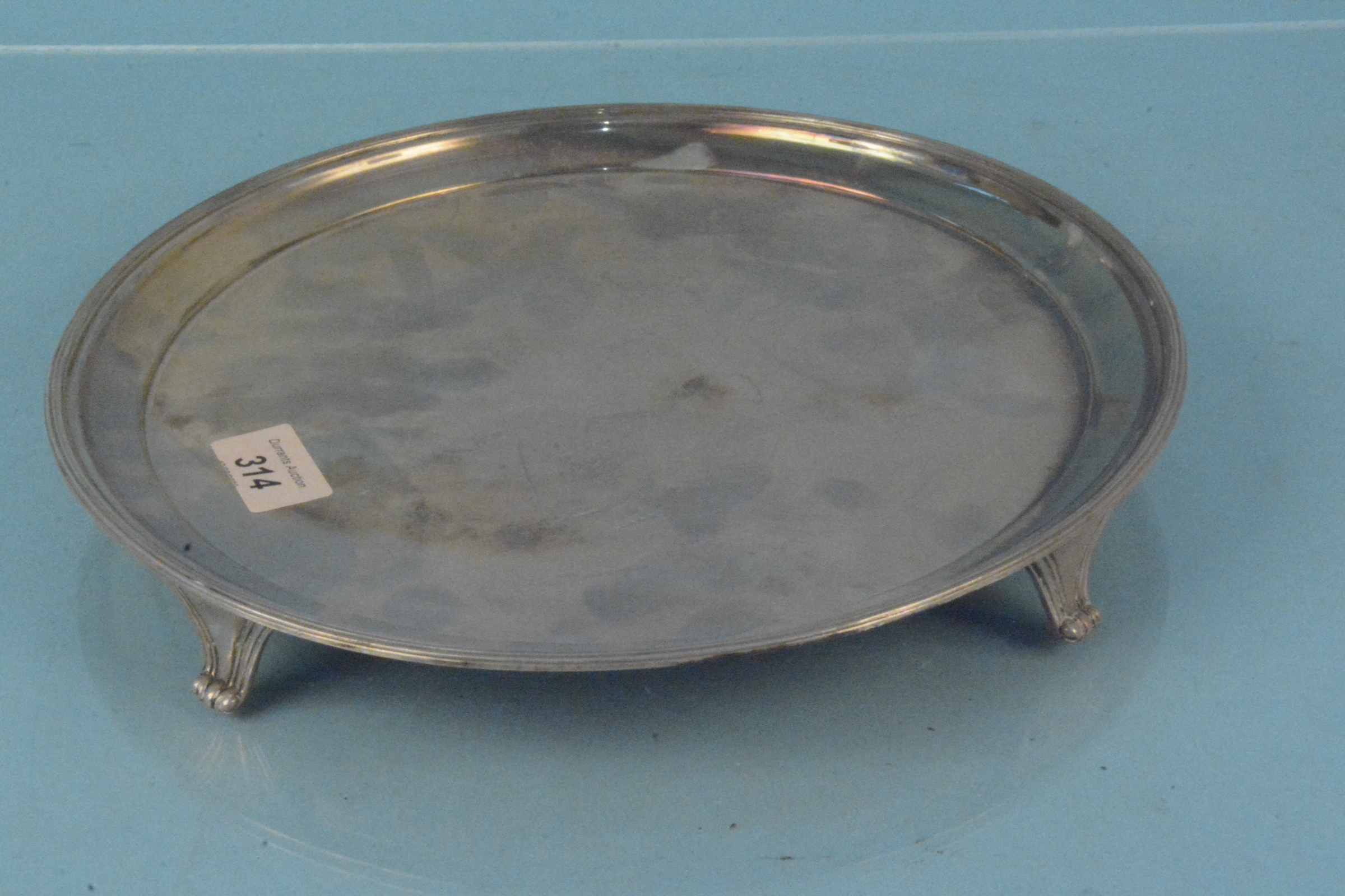 A circular silver salver on four feet, hallmarked Sheffield 1976, - Image 2 of 3