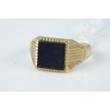 A 9ct gold onyx set signet ring with engraved shoulders (shank misshapen), weight approx 3.