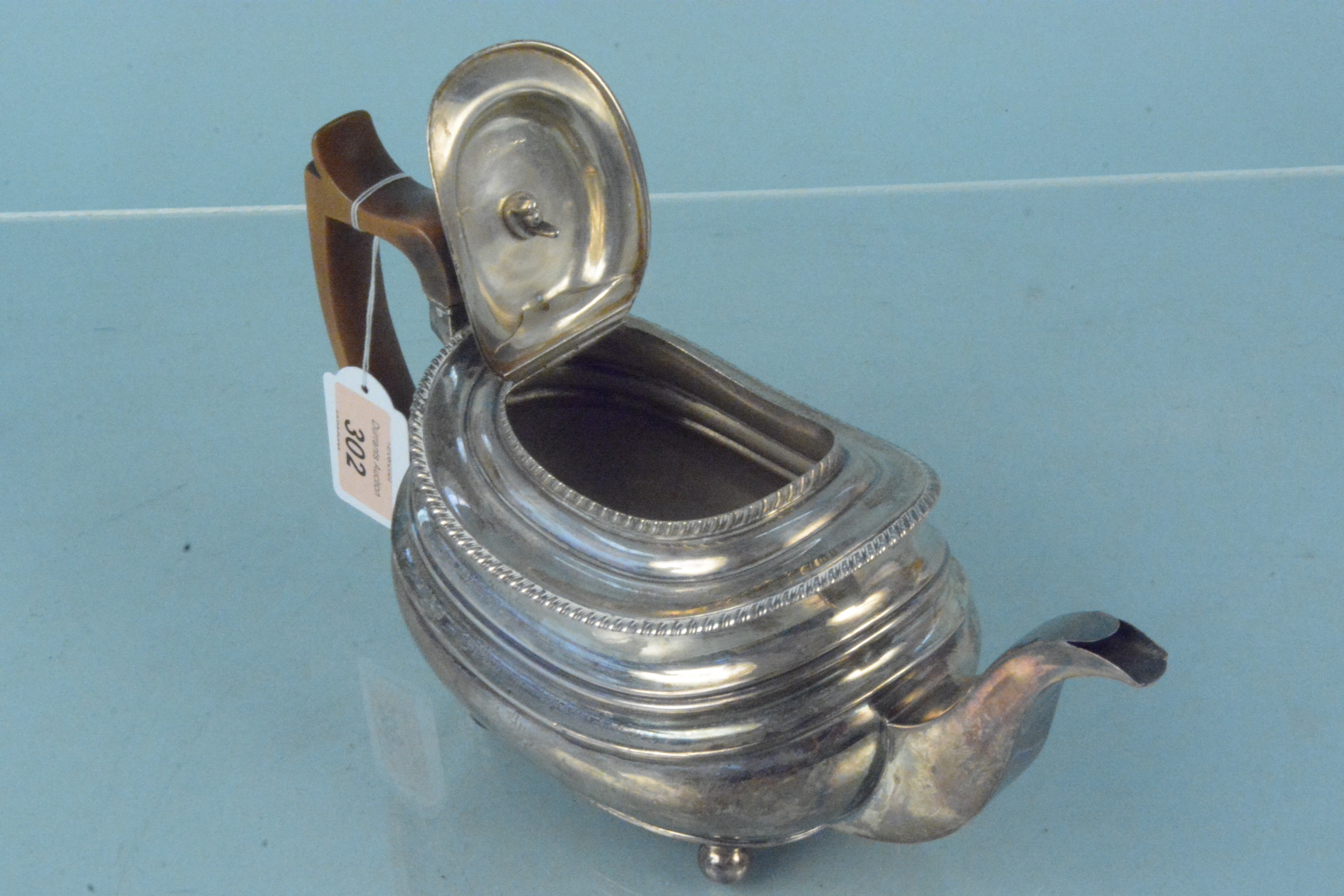 A Georgian silver teapot with wooden handle and engraved crest, hallmarked London 1818, - Image 2 of 3