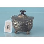 A silver tea caddy with wooden finial on four bun feet, hallmarked Sheffield 1902,