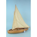 A vintage planked wood constructed two sail model boat,