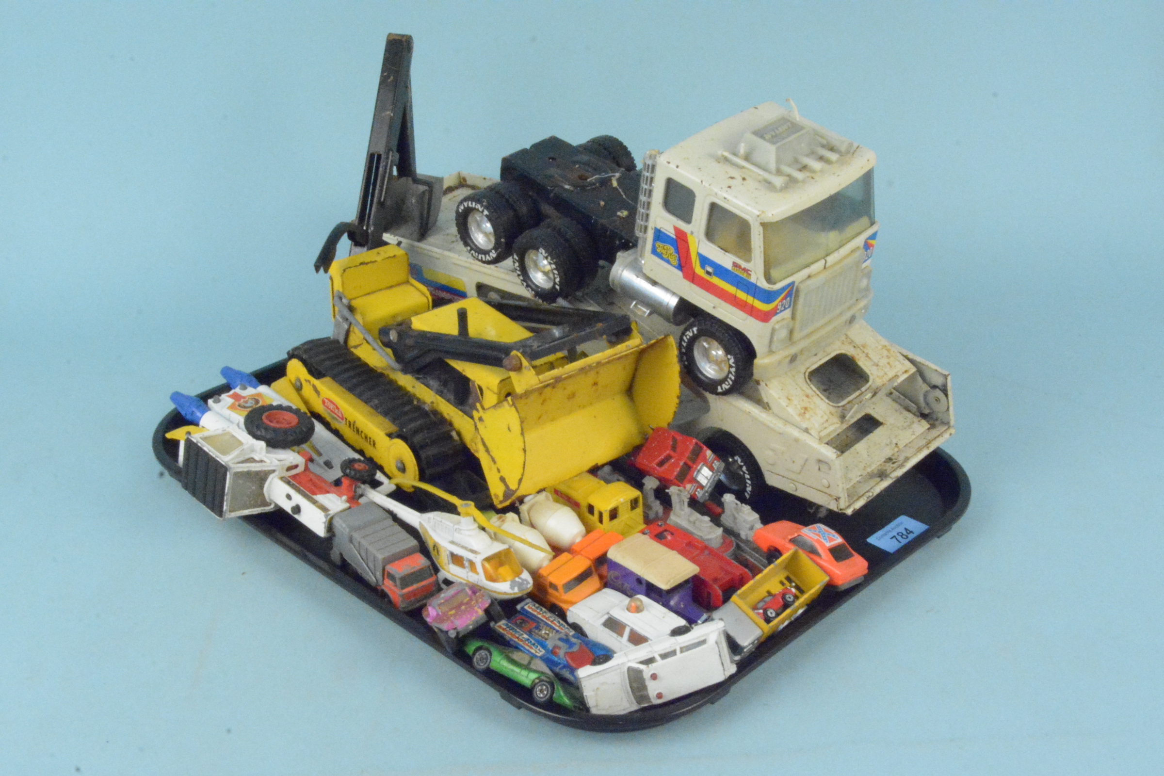 A vintage Tonka Trencher plus a large tin plate transporter and a selection of vintage die cast