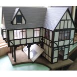 A heavy wooden construction Tudor style dolls house,