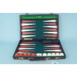 A travelling backgammon set in suitcase (age related wear)