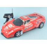 A large radio controlled racing car with handset,
