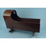 A 19th Century mahogany rocking crib, suitable for dolls,