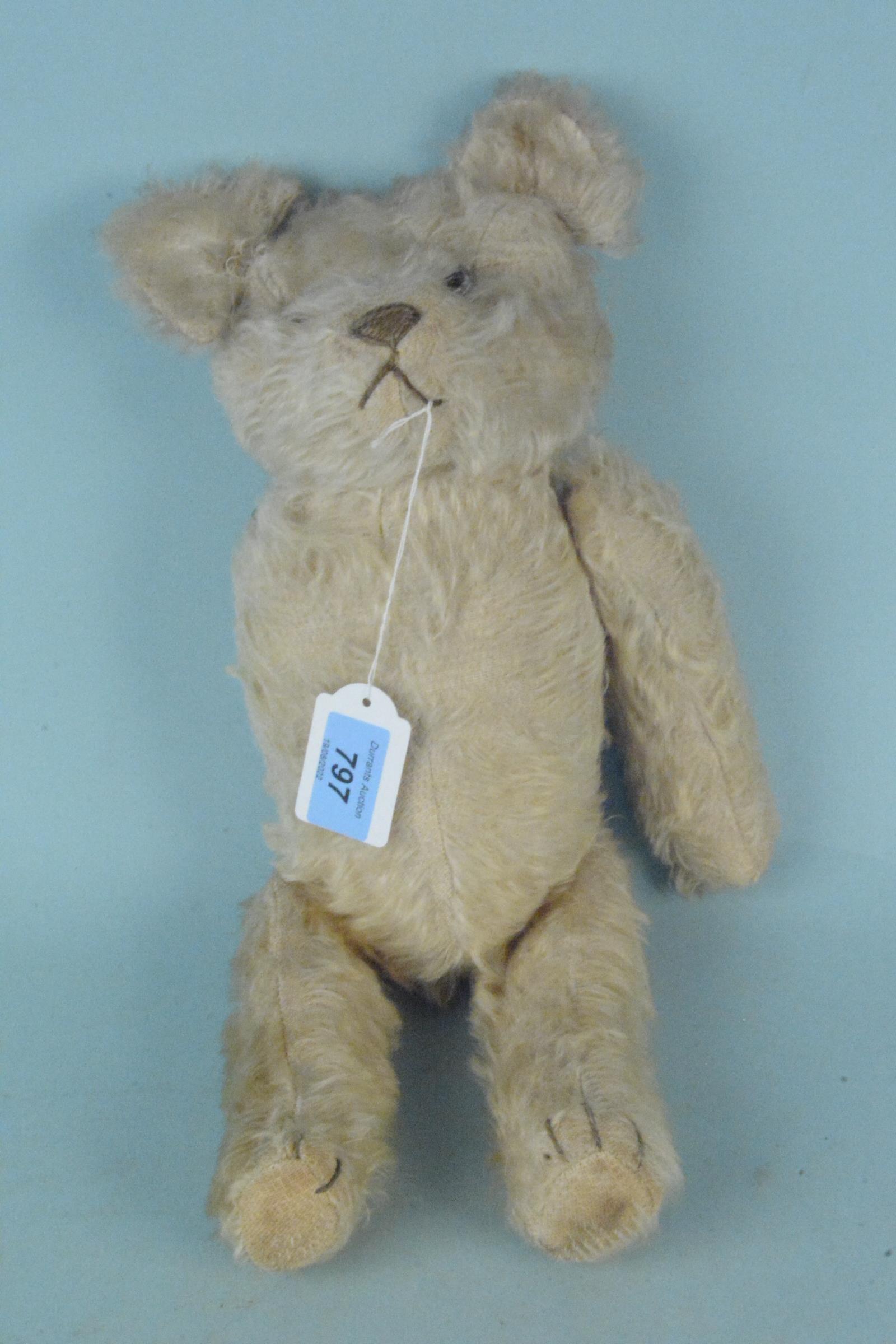 A vintage mohair one armed Teddy bear with inner chimes,