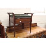 An Edwardian mahogany upholstered piano stool