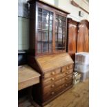 An early 19th Century mahogany bureau on later plinth base, well fitted interior,