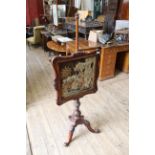 A mid 19th Century mahogany pole screen on well carved tripod base,