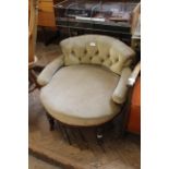 A late 19th Century upholstered tub chair on turned legs