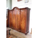 A very large mid Victorian mahogany four door wardrobe with barley twist columns