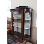 An Edwardian inlaid mahogany display cabinet with bowed glass sides, approx.