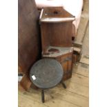 An Edwardian oak corner unit and a carved oak three legged table