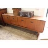 A mid Century sideboard by Nathan with three cupboards and three drawers on tapered legs (one as