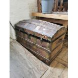 A vintage canvas and metal bound traveling trunk