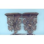 A pair of carved wooden wall sconces with plaster moulded deer figures (both with damage and