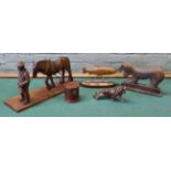 A carved wooden cart horse and farmer on an oak base, a turned wooden money box,