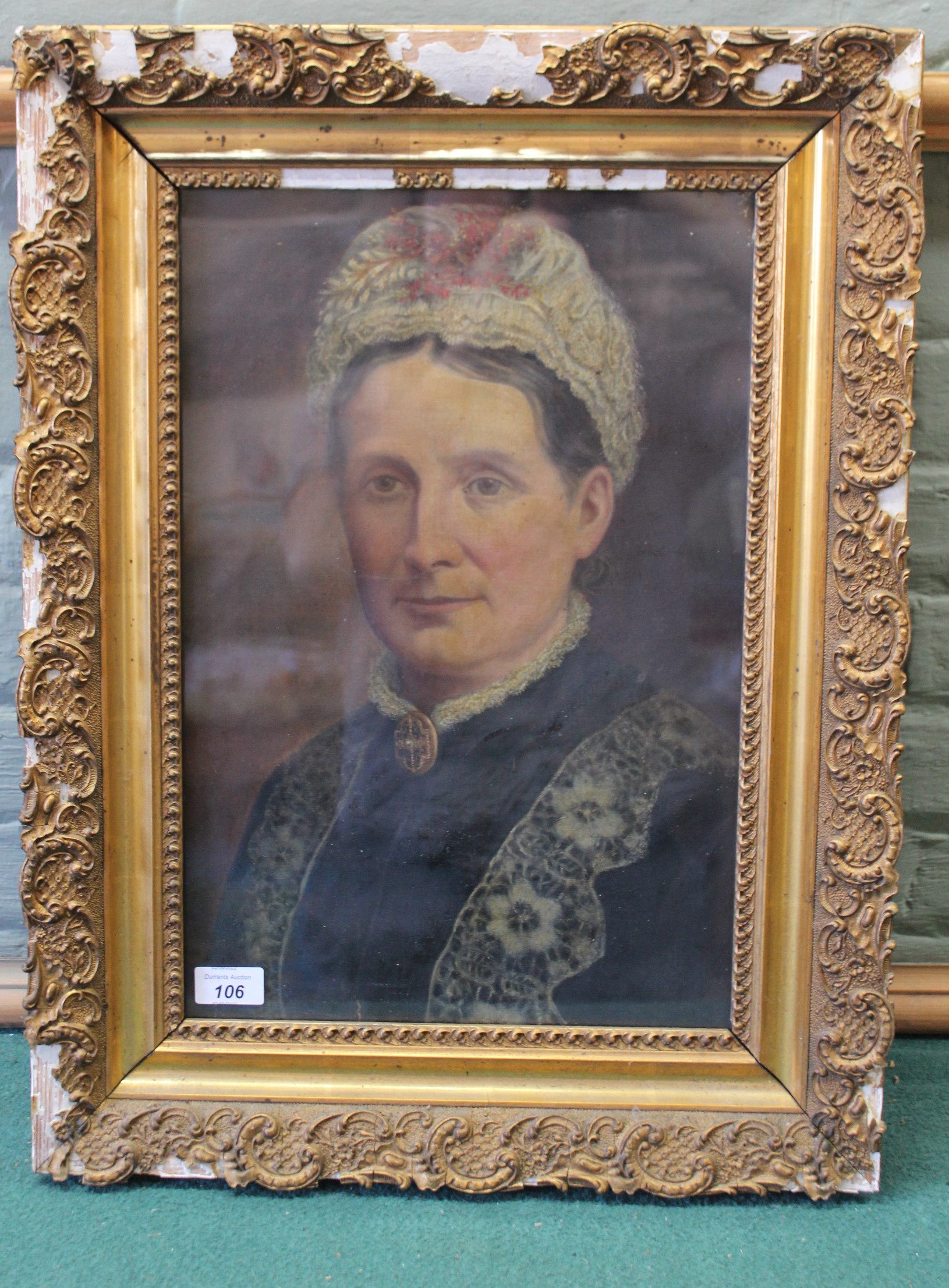 A 19th Century oil on canvas portrait of a woman wearing a brooch,