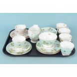 A six setting Shelley green and rose peony pattern tea cups and saucers with six matching side