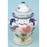 A decorative Oriental style hand painted ginger jar with applied elephant head decorations