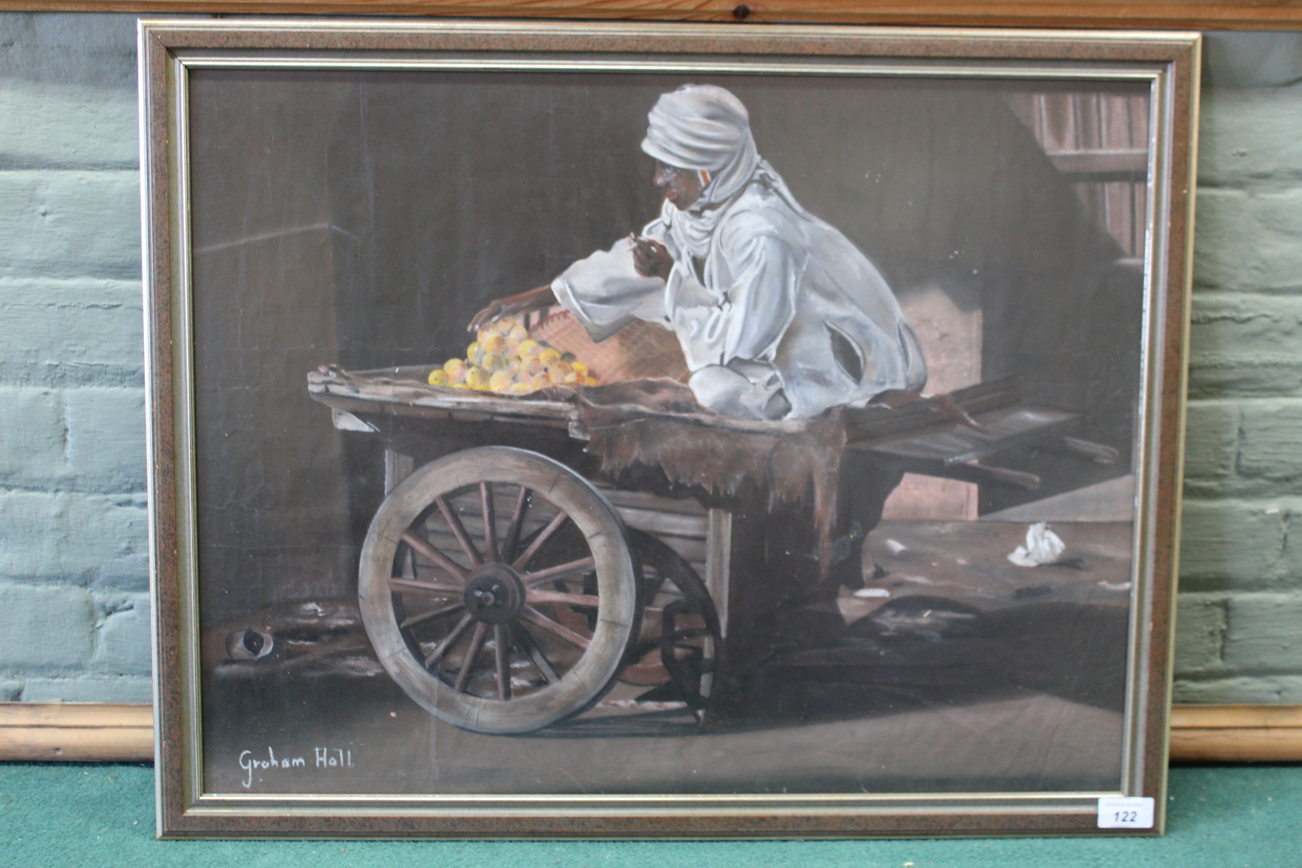 A mixed media oil painting of an ethnic market trader, signed Graham Hall, 49cm x 63.