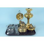 A brass base oil lamp together with two brass reserves,