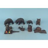Five Black Forest carved wooden bears a carved owl inkwell and a wooden performing bear toy