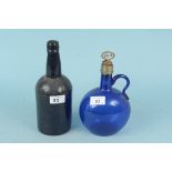 A vintage hand blown Bristol blue glass port decanter plus an antique very dark green glass bottle