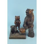 A carved wooden Black Forest seated bear, a standing bear,