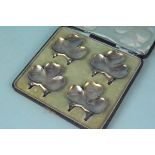 A cased set of four silver three leaf clover ashtrays, hallmarked Birmingham 1904,