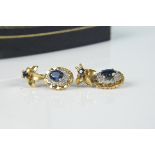 A pair of 18ct two colour gold sapphire and diamond set earrings,