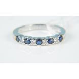An 18ct white gold sapphire and diamond set ring, size L,