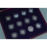 A part set of 2011 Olympic 50p coins in mahogany type case including a London 2012 £5 coin and a