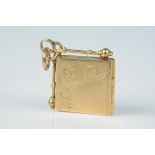 An 18ct gold square shaped locket with foliate engraved decoration (with 9ct gold link to top)