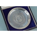 A cased silver tray inlaid with George V British India 1918 rupee,