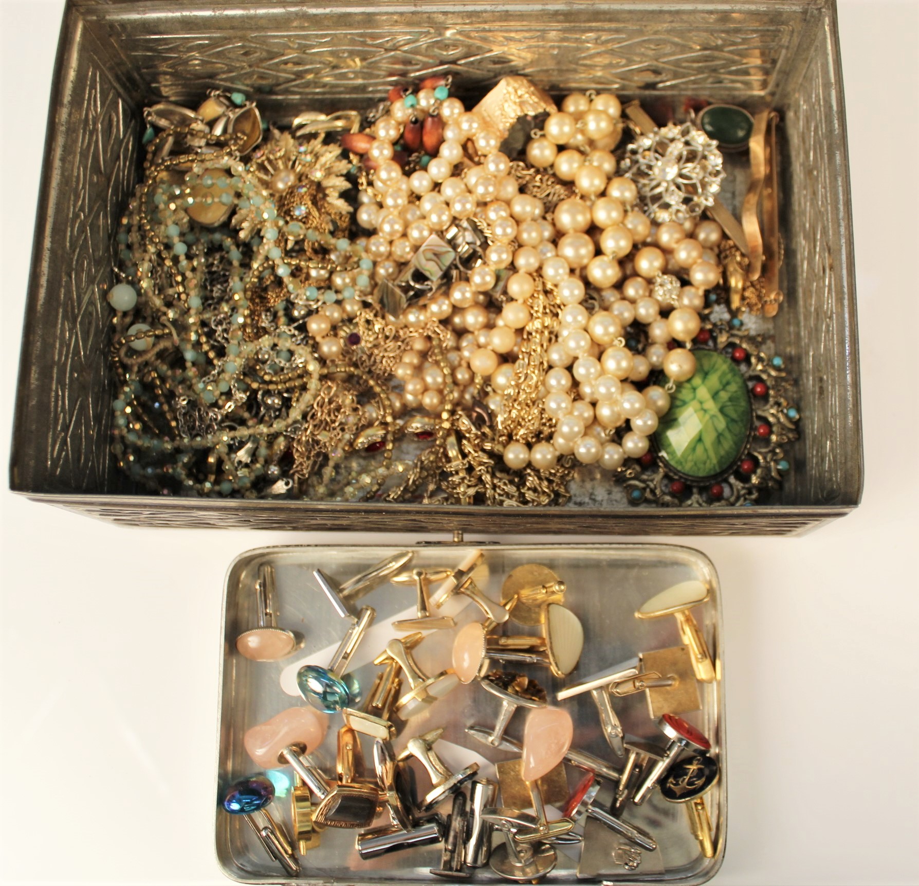 A Mackintosh's tin of mostly metal costume jewellery and a quantity of cufflinks