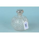 A large spherical cut glass silver lidded perfume bottle,