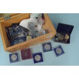 A box of mixed mainly British coins including commemorative crowns and some silver coins