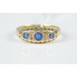 An 18ct gold sapphire and diamond ring (two diamonds missing and centre sapphire damaged) size N,