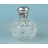 A globular cut glass silver lidded perfume bottle,