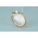 An Art Nouveau style 9ct gold photo pendant with stone set border