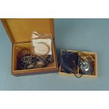 A small wooden box containing costume jewellery