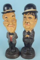 A pair of wooden style figures of Laurel and Hardy,