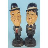 A pair of wooden style figures of Laurel and Hardy,