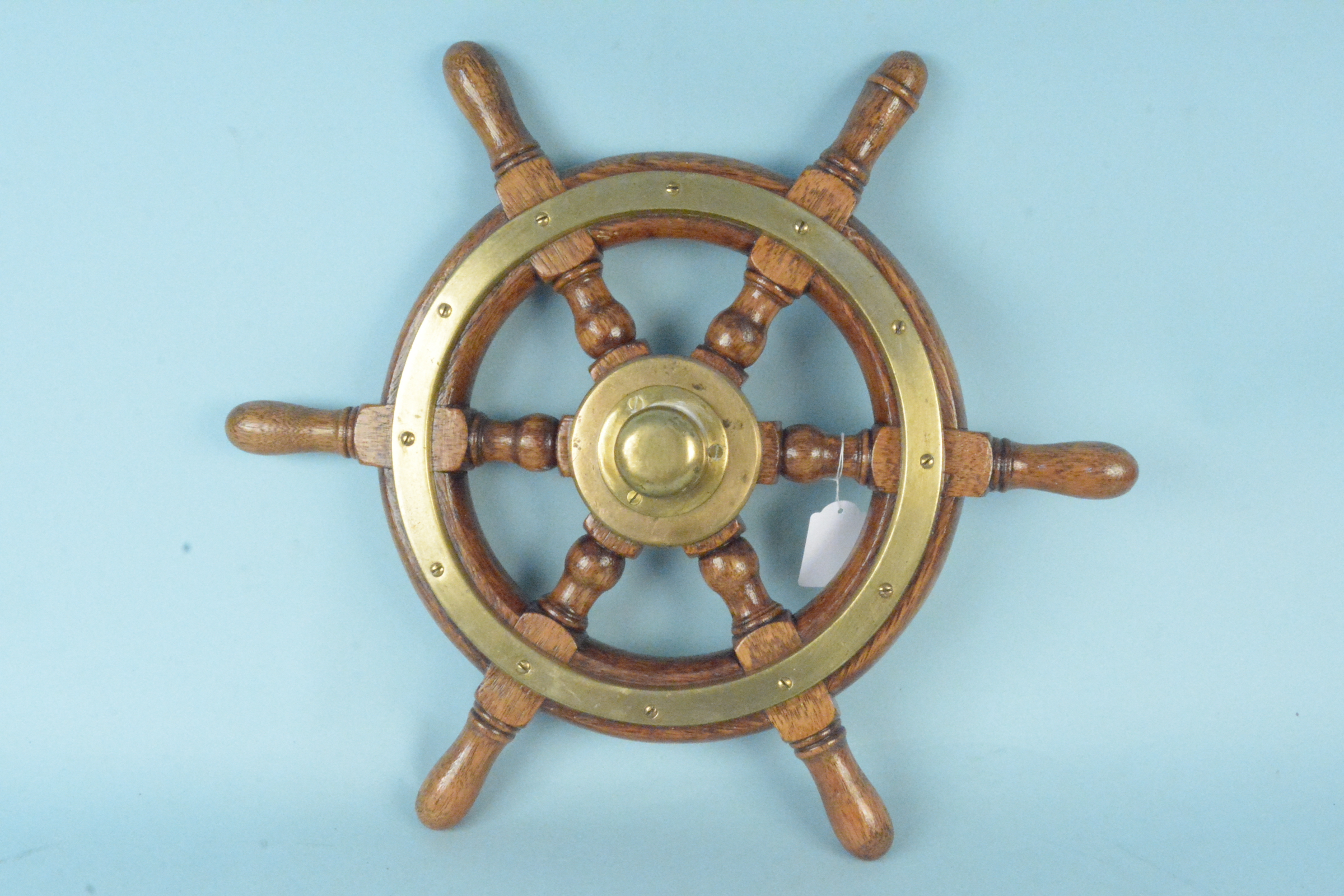 A vintage wood and brass ships wheel,