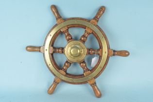 A vintage wood and brass ships wheel,