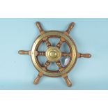 A vintage wood and brass ships wheel,