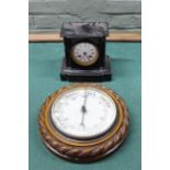 A late 19th Century black marble mantel clock plus a carved oak aneroid barometer